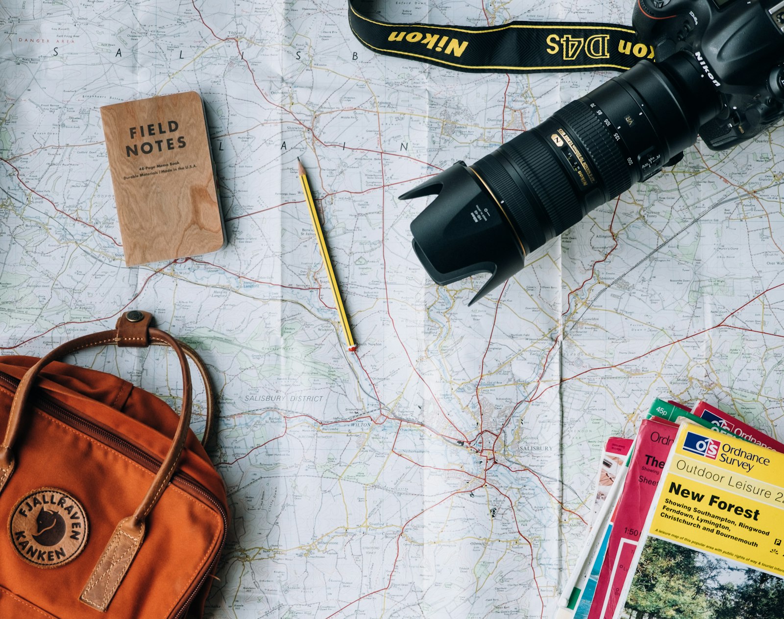 Passport, camera, and travel essentials laid out — best travel credit cards summer 2026