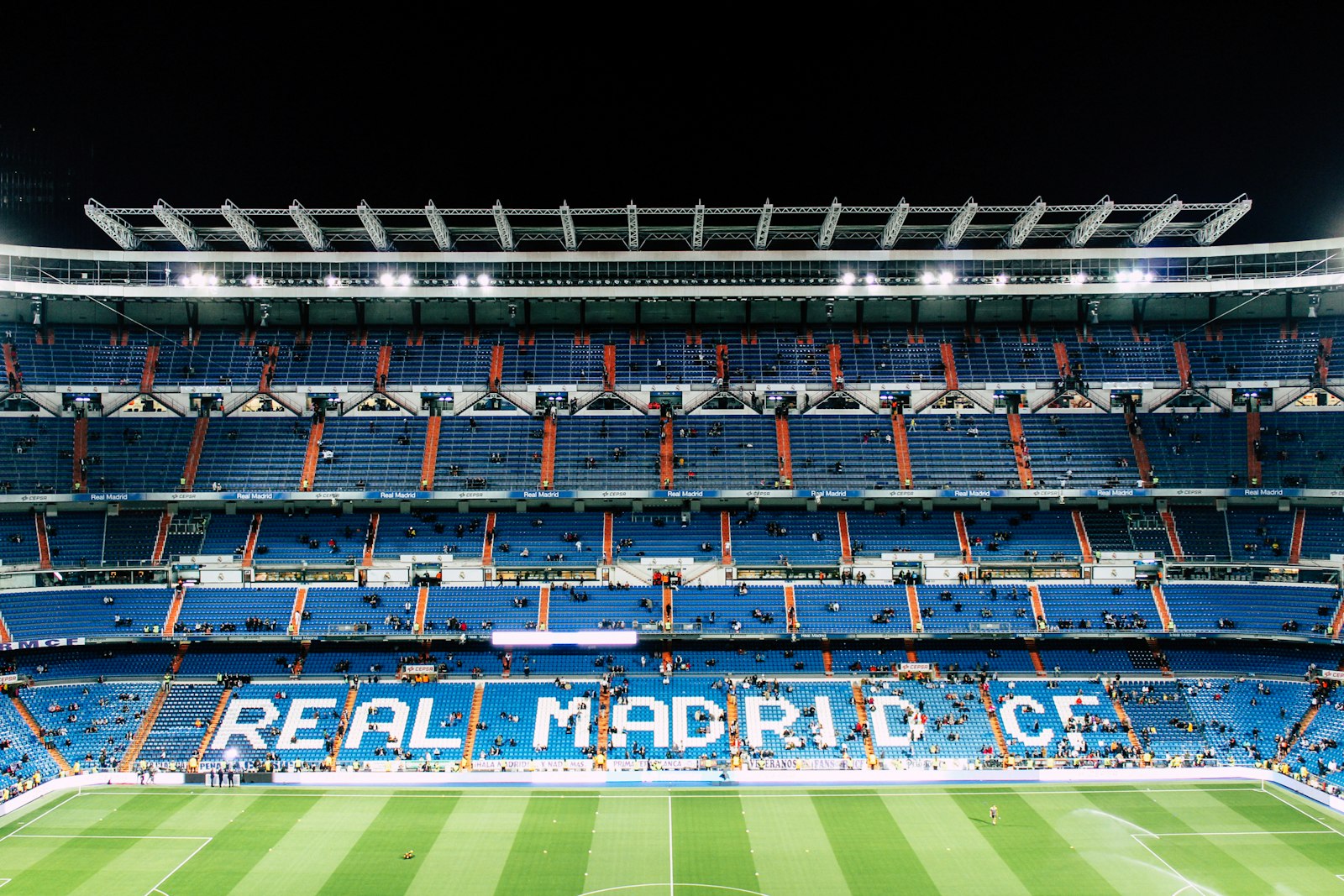 Aerial view of a soccer stadium illuminated at night — World Cup final week travel